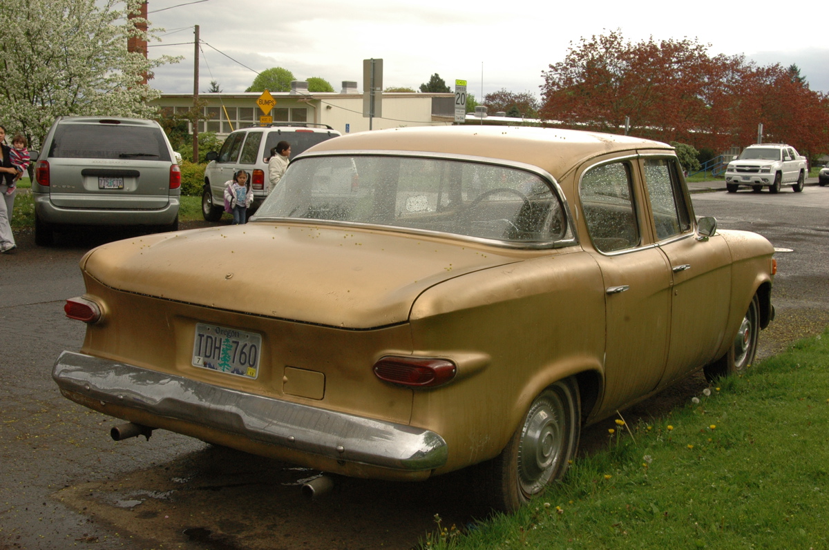 OLD PARKED CARS.: Pair of Larks: 1960 Studebaker Lark VIII sedan.