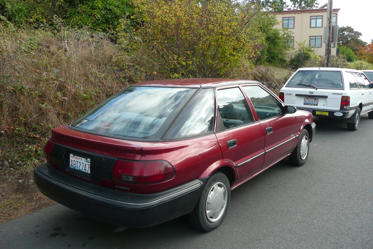 OLD PARKED CARS.: 1991 Geo PRIZM.