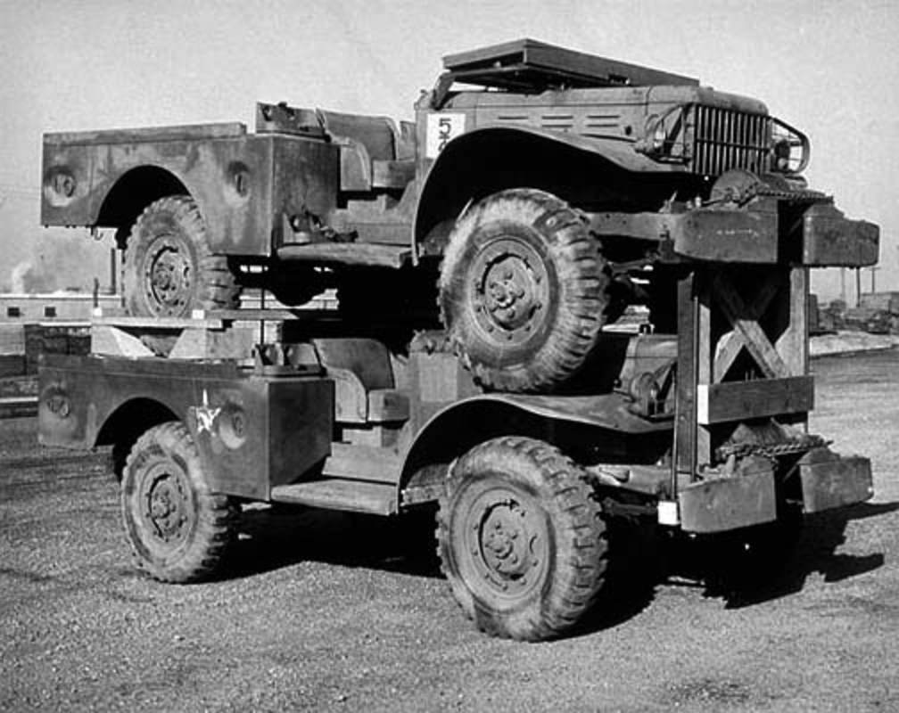 A pair of WC-52 3/4 ton 4x4 weapons carrier trucks packed for shipment at