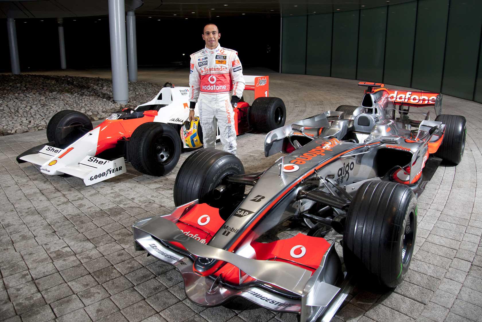 Lewis Hamilton with the McLaren MP4-23 (2008) and MP4-2C (1986)